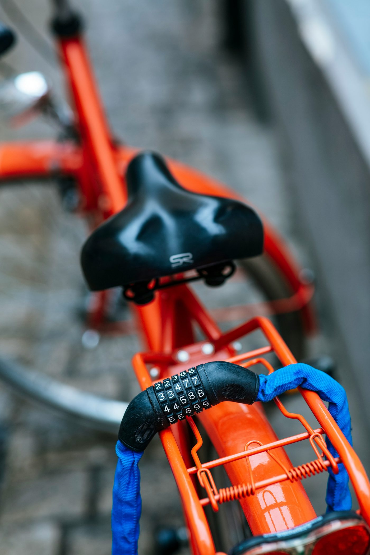 Combination lock resting on the rear rack of a bicycle