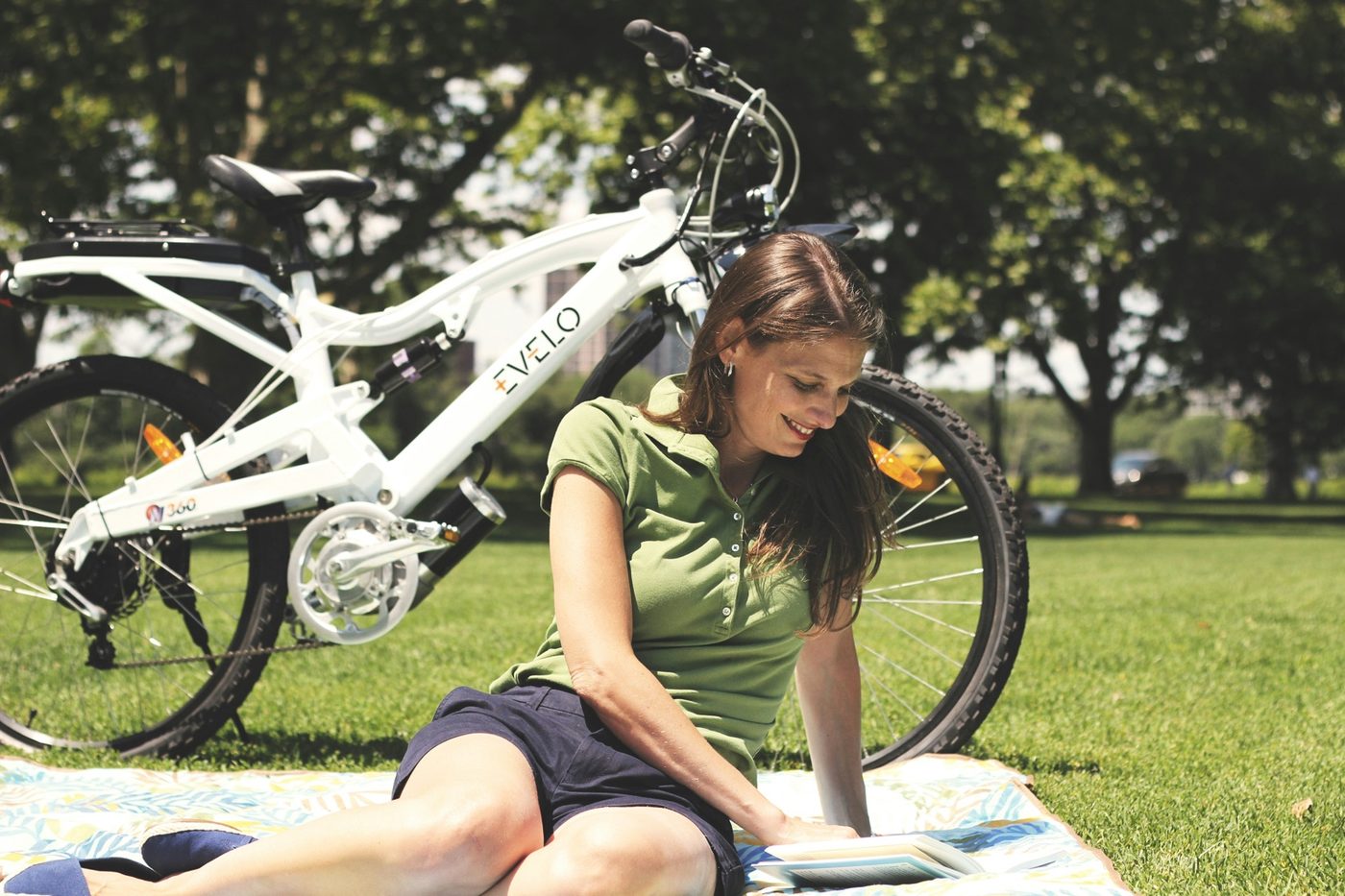 Relaxed step-through e-bike parked beside a rider in a park