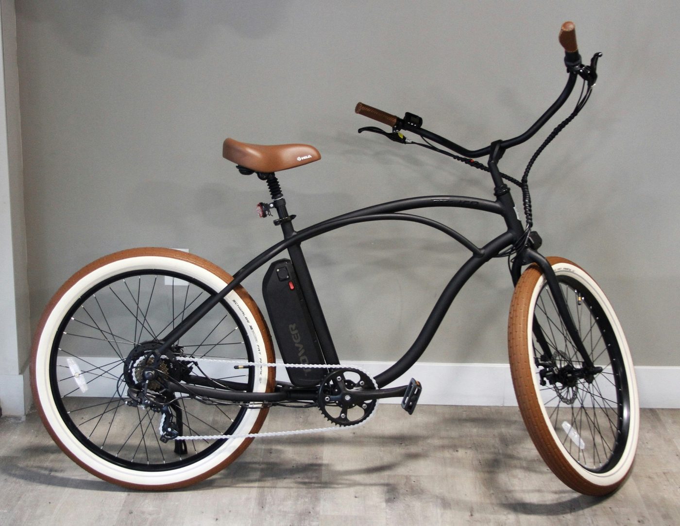 Cruiser-style step-through e-bike side profile against a neutral backdrop